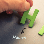 Close-up of a hand placing green letters “H” and “R” to form “HR” representing Human Resources in a healthcare organization.