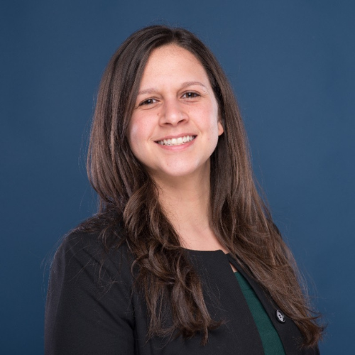 Monique Boudreaux, a professional Systems and Marketing Manager, smiling confidently in a business setting.