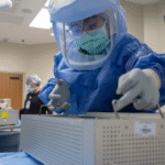 Operating room staff manage surgical trays in a sterile environment—efficiency and standardized workflows support healthcare management associates in delivering high-quality patient care.