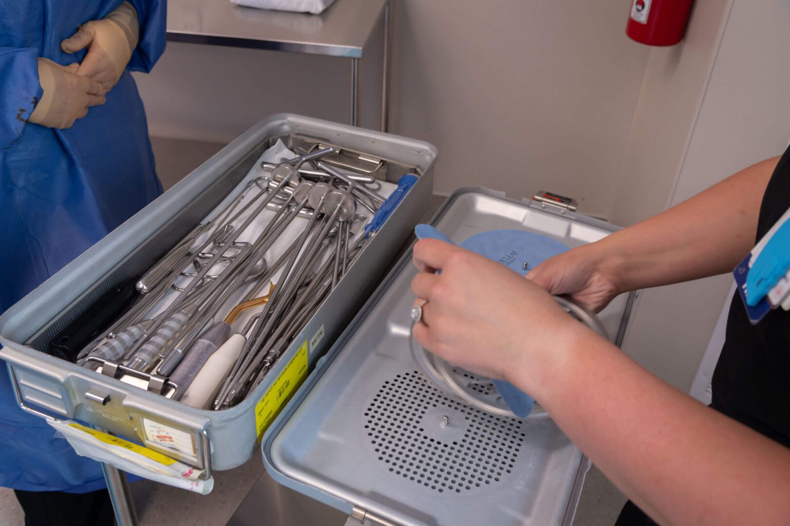 Medical instruments being prepared in sterile tray.